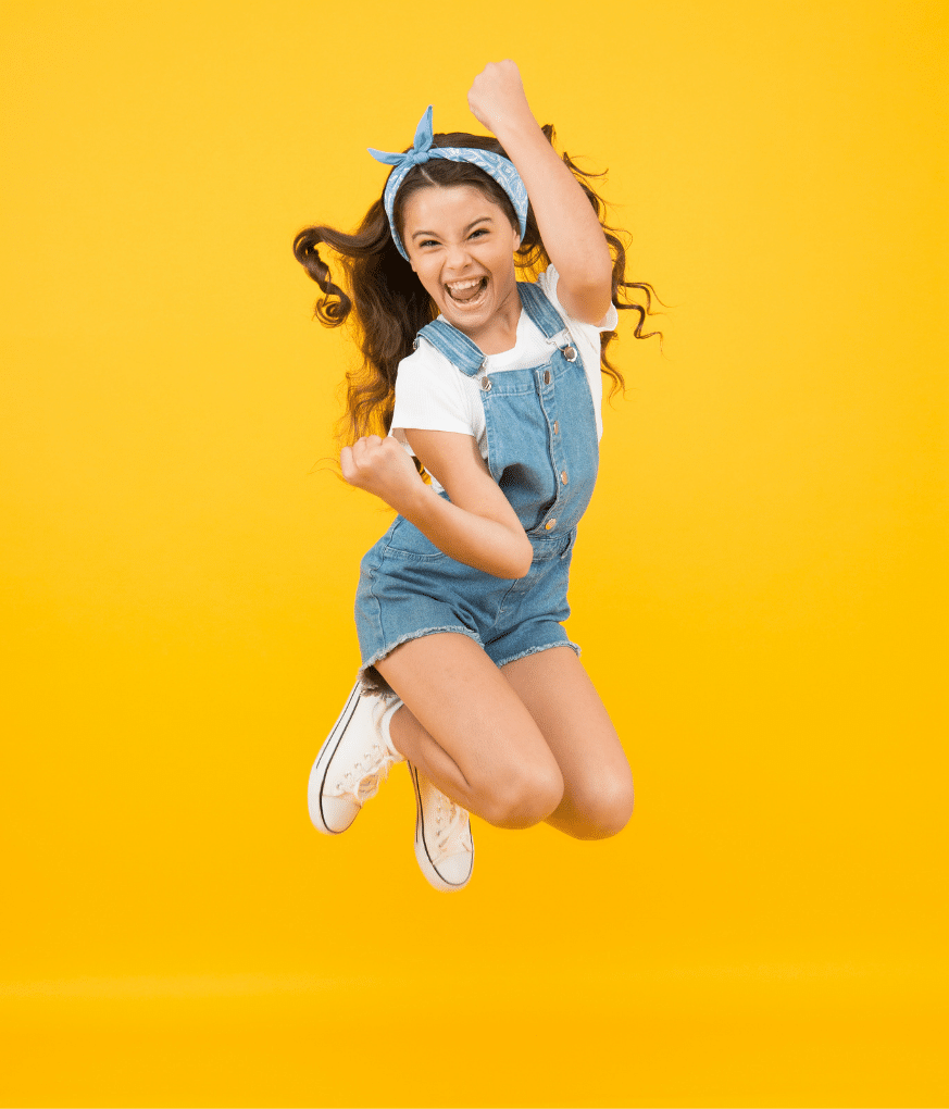Girl jumping on yellow background