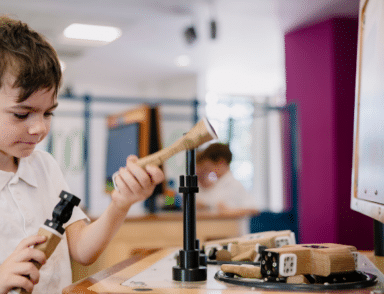 boy working out STEM exhibit at science centre